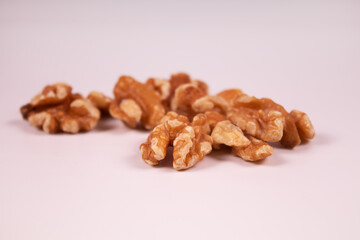 several pieces of peeled walnuts lie nearby