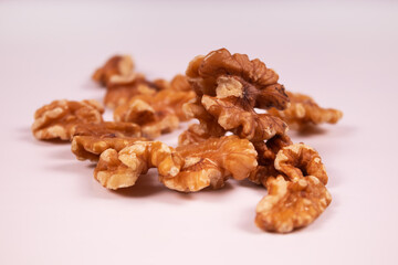 peeled walnuts piled in a heap in the center of the frame