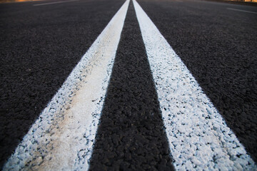 Fototapeta premium Road markings on asphalt on the street.