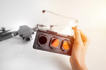 woman holding ND filters and polarising filters set for drone. Filters for the drone camera. 
