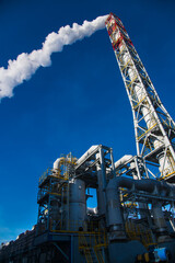 Pipes of an industrial enterprise against the sky
