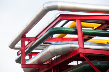 Steel pipelines, valves and ladders in an industrial enterprise