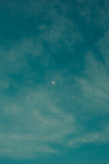 Minimalistic sunset with a moon and clouds