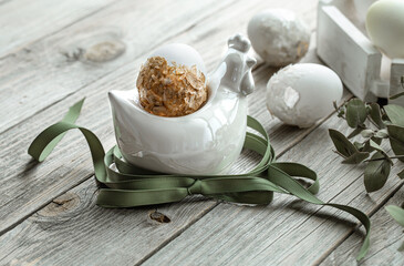 Spring easter composition with eggs and plants on wooden surface close up.