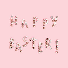 Words  Happy Easter from Chocolate Quail eggs on pastel background. Small pink egg, spring Easter holiday