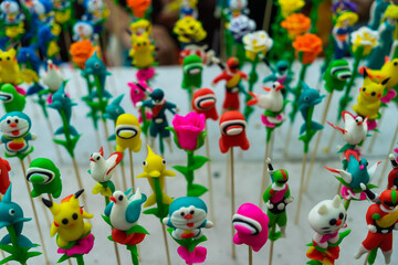 Fototapeta na wymiar To He (toy figurine) is a traditional toy for children in Vietnam which is made from glutinous rice powder in form of edible figurine such as animals or characters in folk stories