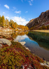 Fototapeta na wymiar Arpy Lake and the surrounding area during the fall and changing of the colors. Foliage, reflection and snowy peaks