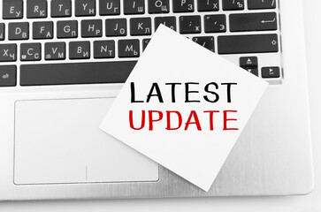 Laptop with memo sticks on the keyboard with text Latest Update on it.