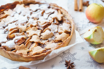 Traditional apple pie on the table with decorations.