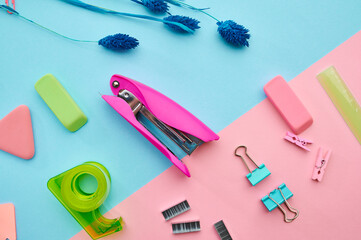 Stapler and clips closeup, blue background