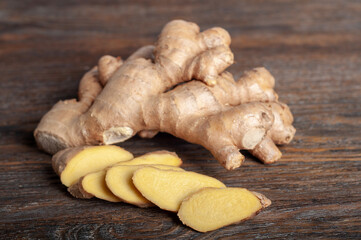 Fresh sliced ginger root on a wooden table.