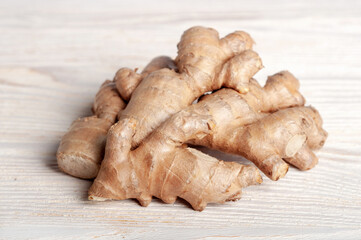 Fresh ginger root on a wooden table.