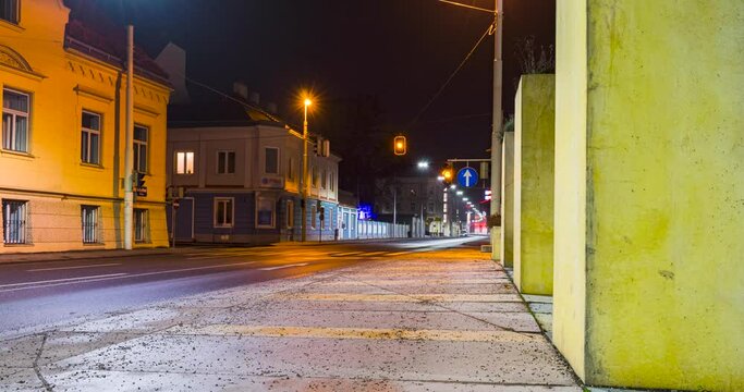 Timelapse of traffic with light trails of cars and city lights at night.