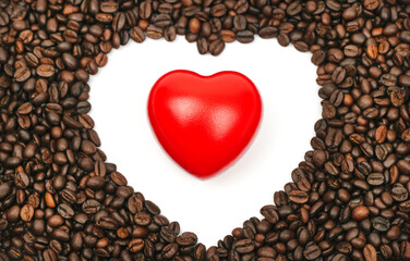 Red heart with Blurred roasted coffee beans on a white background.