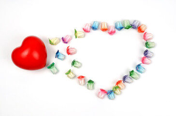 Various colored paper folded in the shape of a rabbit arranged in a heart with a red heart on a white background.