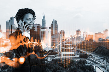 Attractive black businesswoman trader processing conference call to forecast the capital market behavior. Concept of trading strategy. Forex chart. Kuala Lumpur. Double exposure.