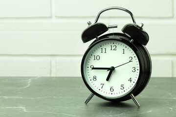 Clock and alarm clock on the table with space for text