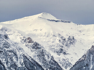 Winter landscape with mountain peaks covered in snow. Beautiful view with Bucegi Mountains part of the Carpathian Mountains, in Romania.
