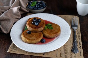 Cheesecakes for breakfast with syrup and blueberries