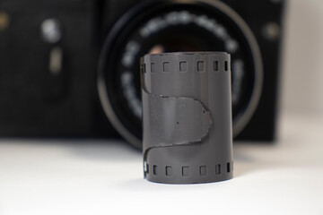 photographic film with blurred old camera in the background