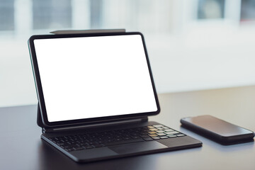 Fototapeta premium Digital tablet with blank screen on black table in office. Mock up.