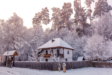 Traditional Romanian village in Transylvania with old house straw roofing covered with snow in a cold day