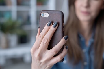 Fototapeta premium close up image of woman holding phone, video calling, using online mobile chat app.