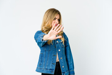 Young caucasian blonde woman rejecting someone showing a gesture of disgust.