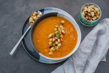 Pumpkin soup on rustic wooden table