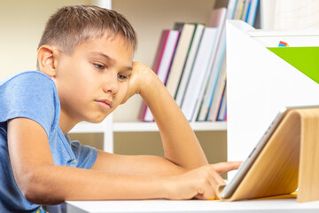 Teenage boy using digital tablet computer. Online learning, remote education, distance lessons, entertainment at home