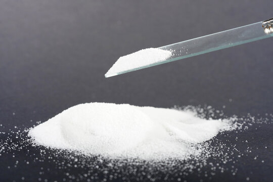 Makrogol powder photographed against a black background in the studio