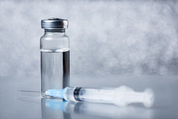 Medical ampoule for injection on gray. Vaccination medicine.