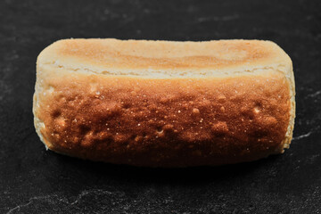 Square loaf of bread isolated on dark background