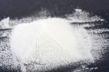 Makrogol powder photographed against a black background in the studio