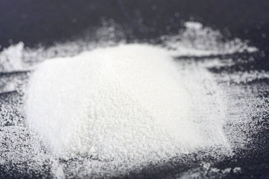Makrogol powder photographed against a black background in the studio