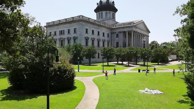 Aerial View of People at Park Having Fun in Front of South Carolina State House, Columbia USA on Summer Day, Slow Motion Drone Shot