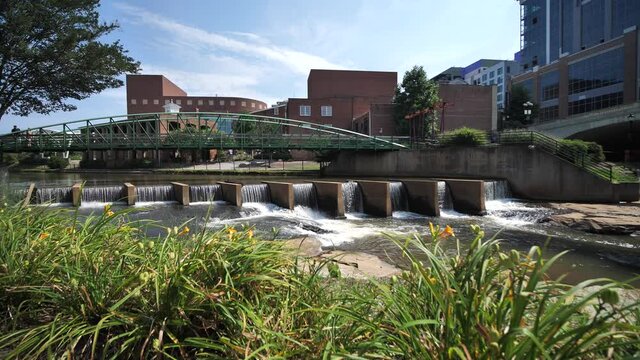 Greenville City, South Carolina USA. Reedy River and Downtown Buildings on Sunny Summer Day, Slow Motion