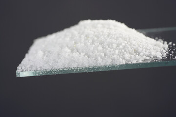 Makrogol powder photographed against a black background in the studio