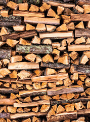 Stacked, alternating pile of split firewood closeup