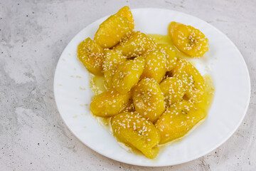 Fried caramelized sweet  plantains. Dominican food. Ripe plantains caramelized with butter and sesame seeds, typical recipe from some Caribbean countries. It is called plantain in temptation or rogue 