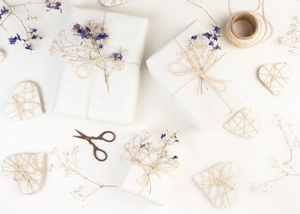 Valentine's Day Zero Waste Concept. Eco-friendly craft paper packaging. Gift Box with a branch of a dried flower tied with jute.