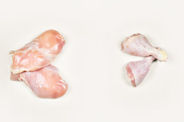 Raw chicken legs and fillet isolated on white background