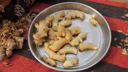 Fresh peeled ginger roots in a steel plate. Indian Zingiber officinale (adarak) used as a spice and a folk medicine