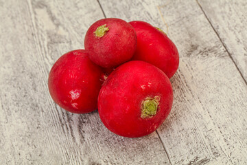 Ripe fresh radish heap over wooden