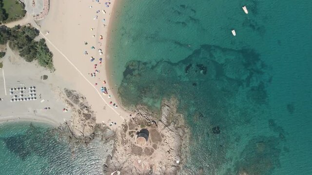 Bari Tower Near Sandy Beach With Colorful Umbrellas And Tourists Enjoying Summer Vacation On A Sunny Day In Nuoro, Sardinia, Italy. - aerial