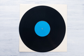 on a light gray background, on a paper envelope, lies a vinyl record, close-up