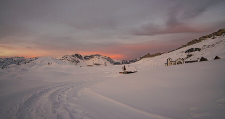 beautiful sunrise in the Swiss alps on a winter day surrounded by snow and mountains in the idyllic...