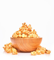 Fototapeta na wymiar Delicious sweet popcorn with caramel in wooden bowl, isolated on white background.