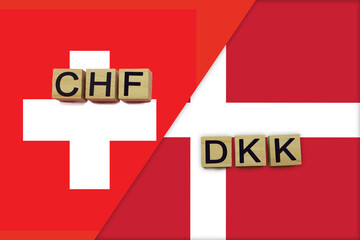 Switzerland and Denmark currencies codes on national flags background