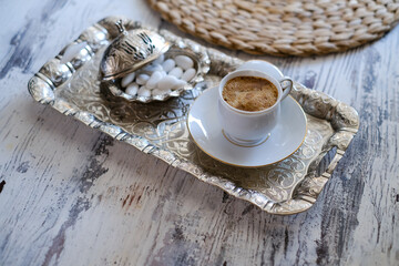 Traditional Turkish coffee over rustic tray